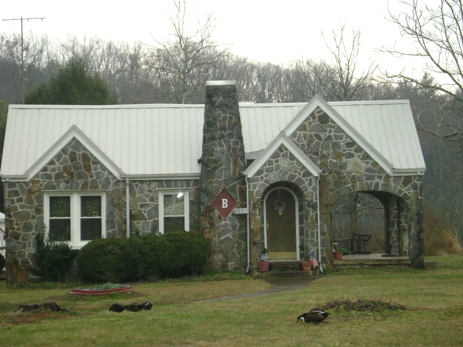 White metal roof on a stone cottage with steep gables in Bishop Hill