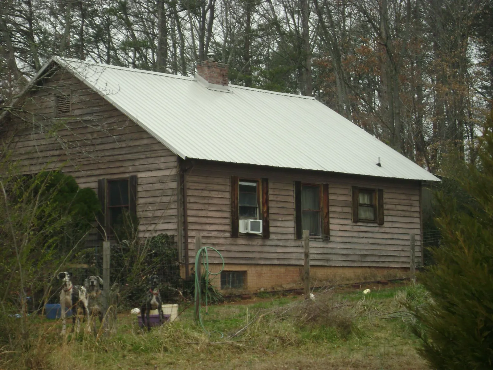 White metal roof on an old wood sided farmhouse, from a Metal Roof Installation job in Bishop Hill
